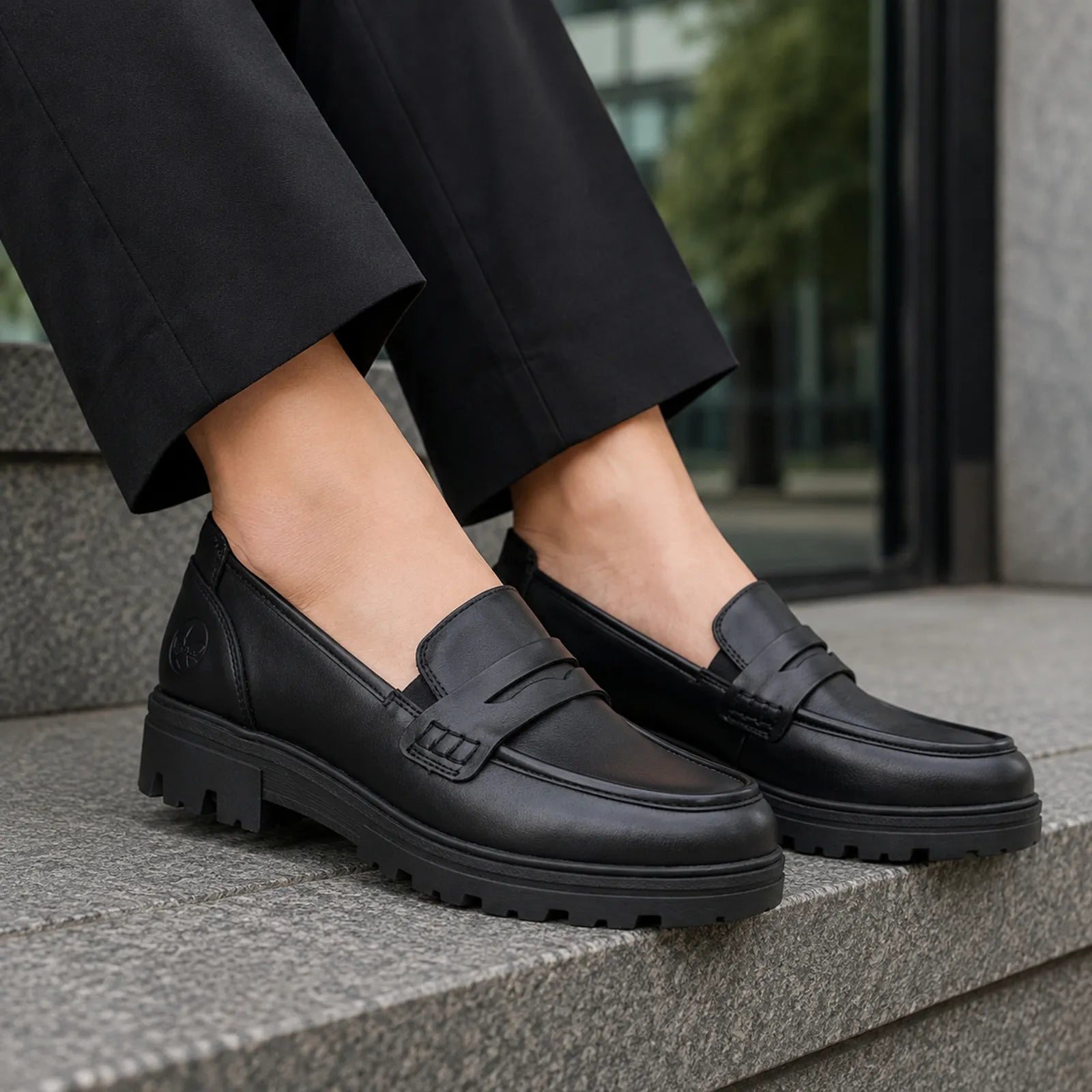 Rieker women's black loafers worn with smart casual outfit, comfortable slip on shoe style