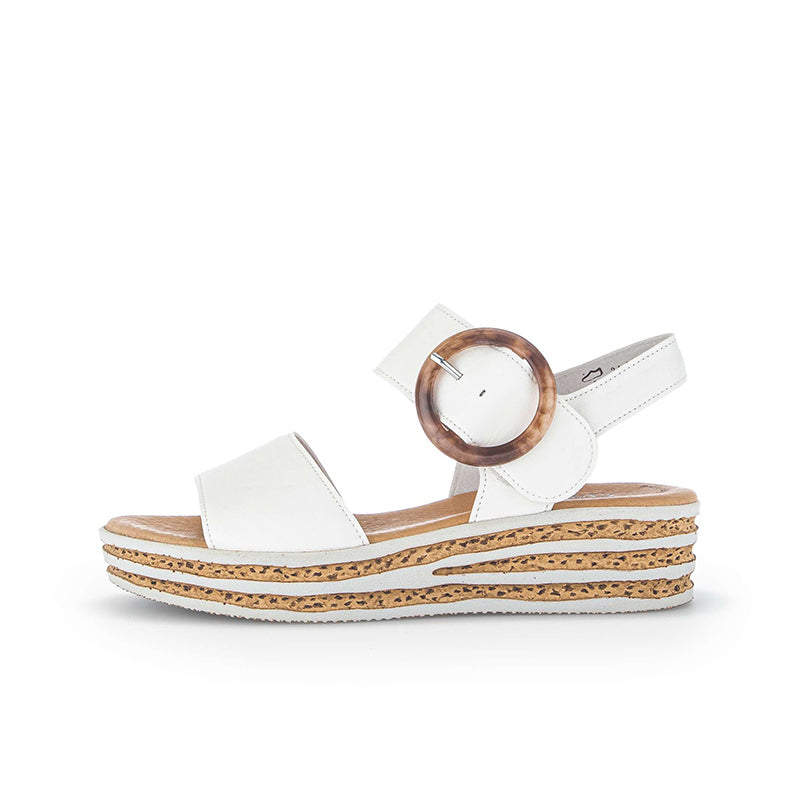 Women’s leather platform sandals in white, angled side view with round buckle and textured sole