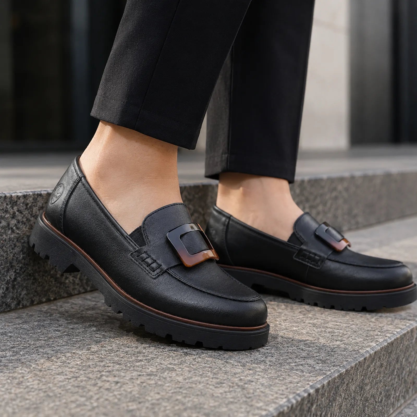 Rieker women's black loafers worn with casual outfit, comfortable slip on style for everyday wear