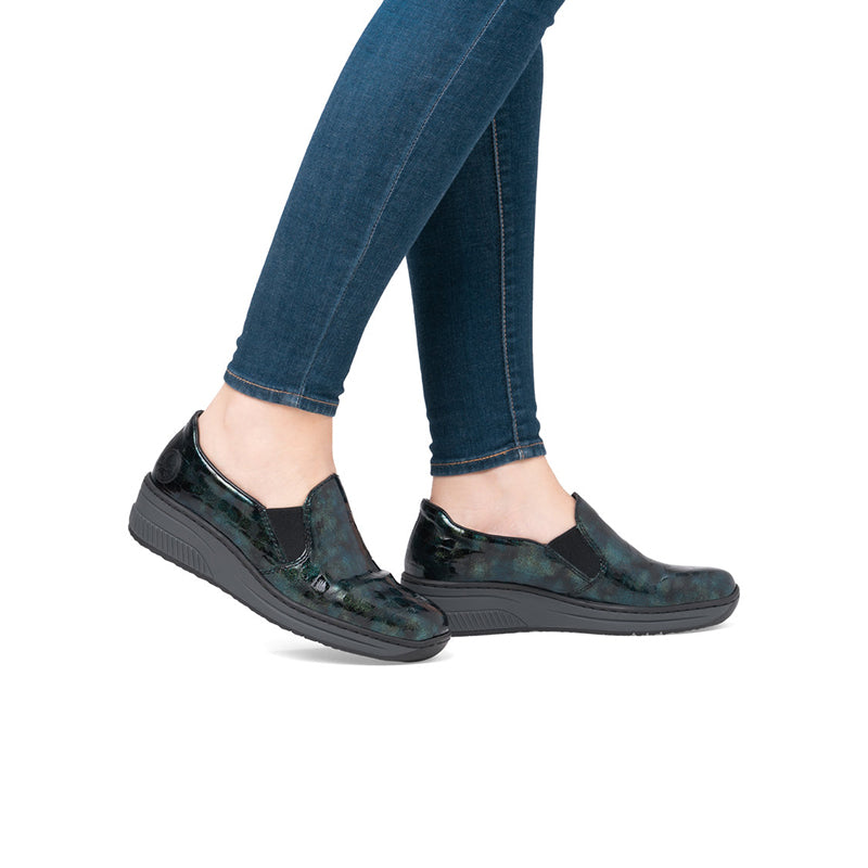 Rieker womens loafers on model, green blue patterned slip-on with wedge sole and jeans