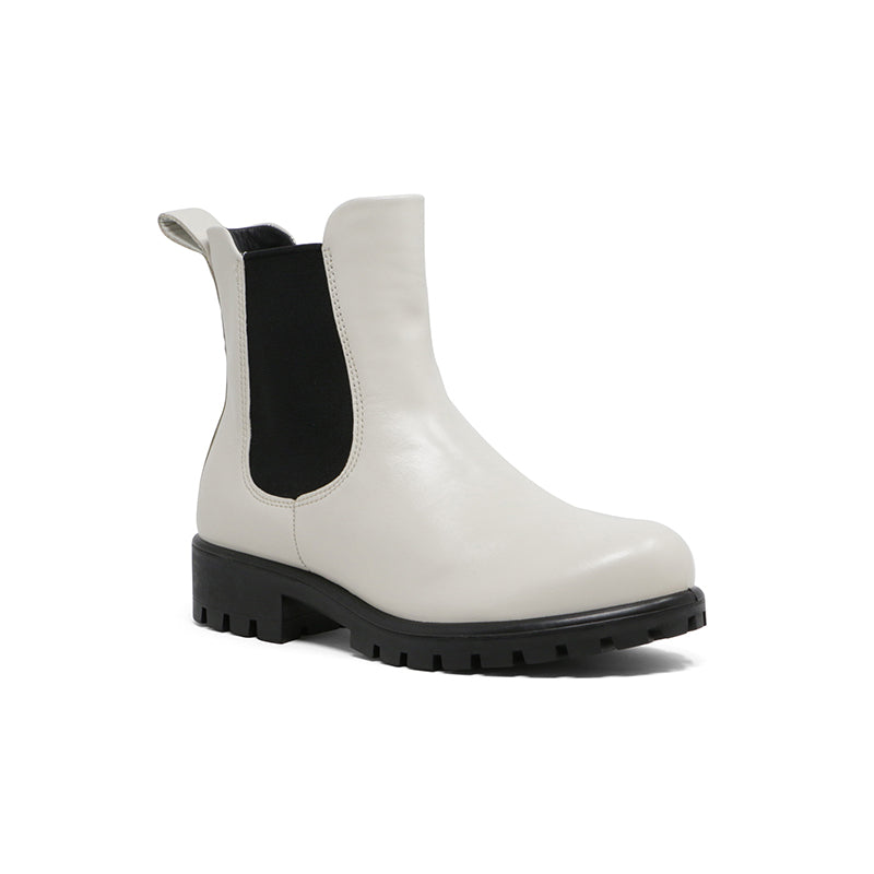 White leather Chelsea boot with black elastic side panels and chunky lug sole