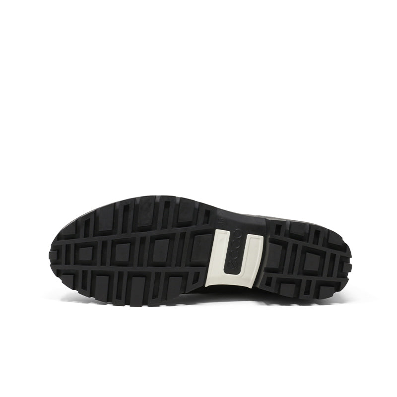 Black rubber boot outsole with square tread pattern and heel grip