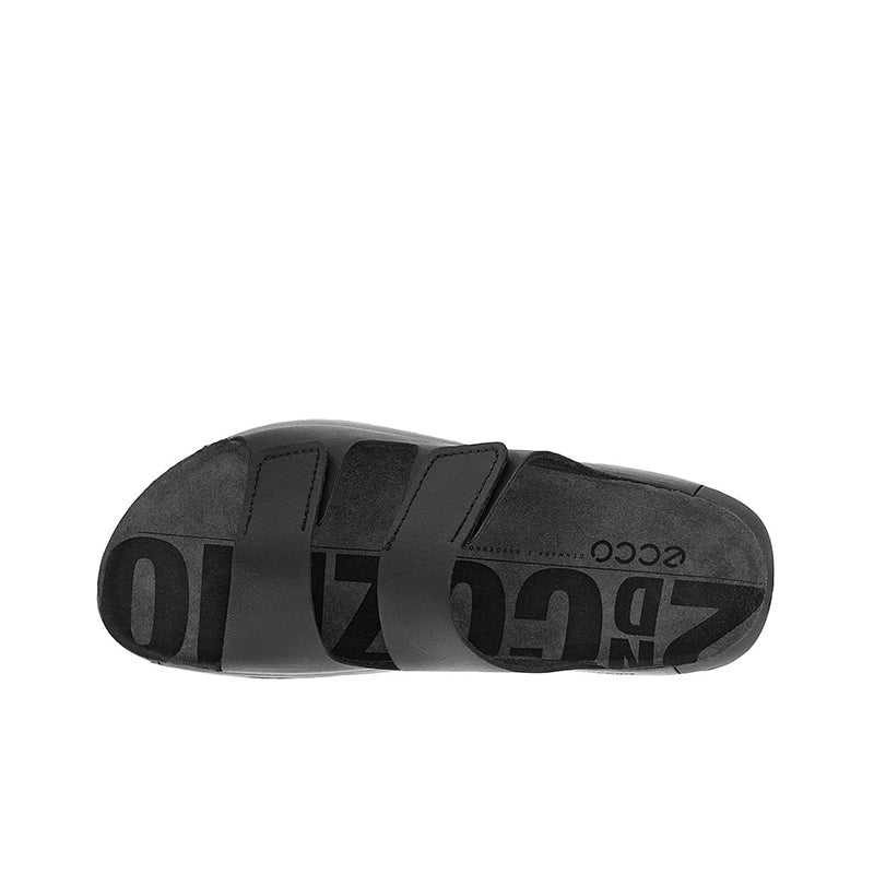 Black outsole of men's two-strap leather slippers with molded traction tread