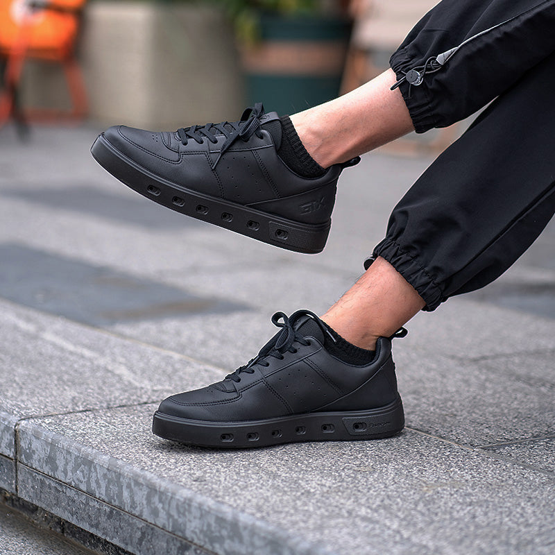 Navy mens sneakers on feet, lace-up design with rubber outsole detail.