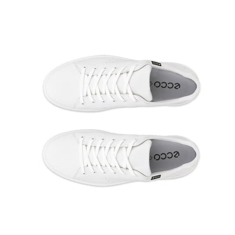 White sneakers shown from side with laces and ecco logo on inner lining
