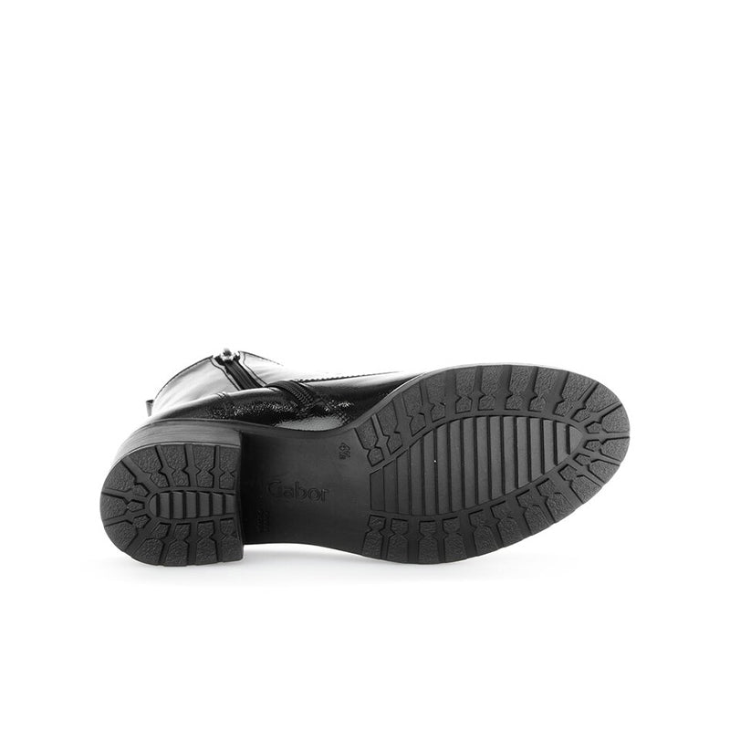 Black leather boot outsole with tread pattern and stacked heel