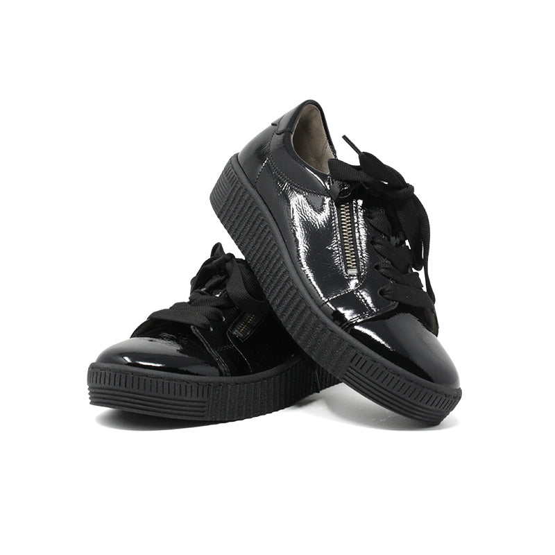 Black glossy low-top sneakers with lace-up and zipper detail, pair view.