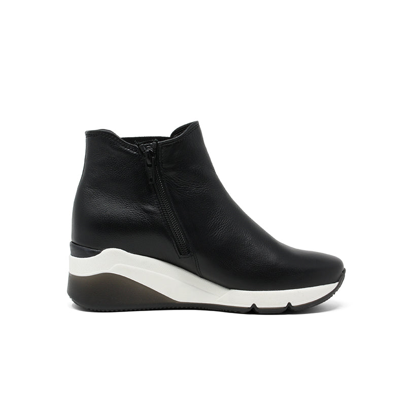 Black leather ankle boot with side zip and white sole wedge