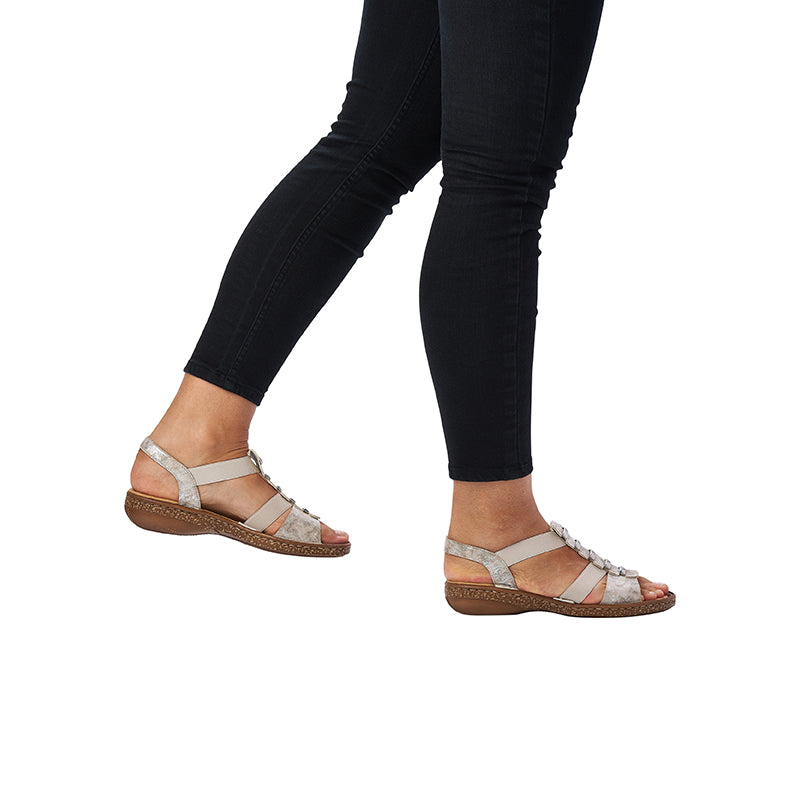Silver and beige flat sandals with cross straps and adjustable buckle