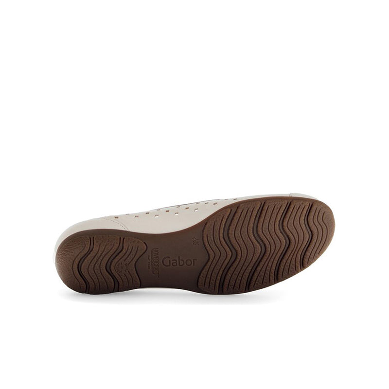 Beige ballet flat outsole with textured tread pattern and brown edge
