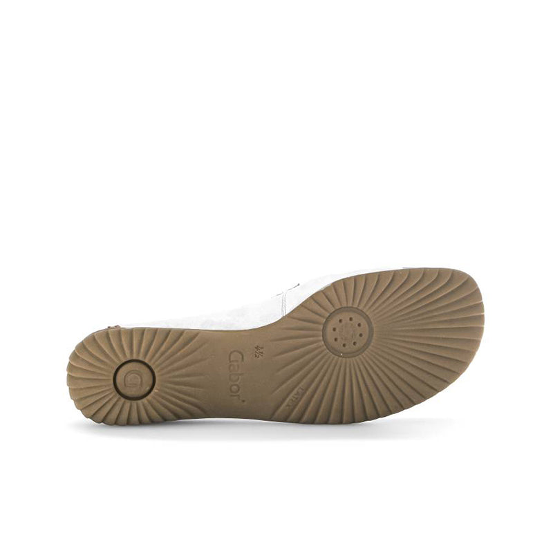 Loafer outsole view with tan traction tread and circular heel pad