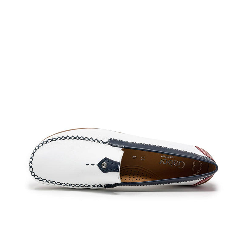 Side view of white leather loafer with navy strap and perforated brown insole