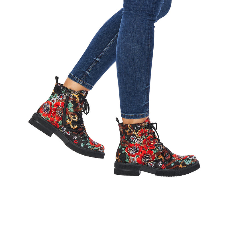 Floral ankle boots worn with blue jeans, red multicolour print, black tread sole