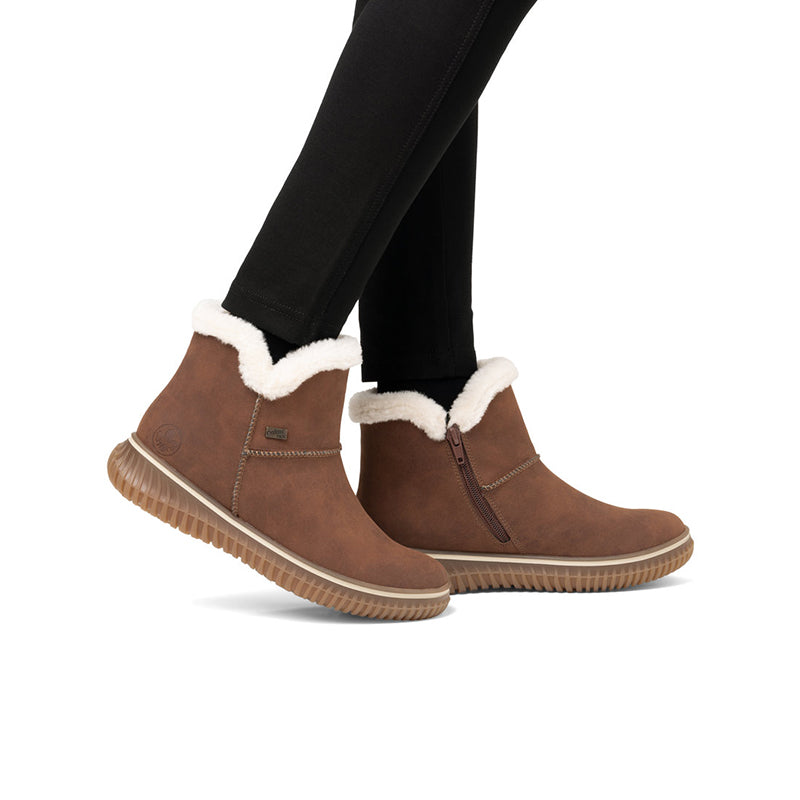 Rieker women¡¯s brown suede ankle boots with faux-fur trim, worn with black pants