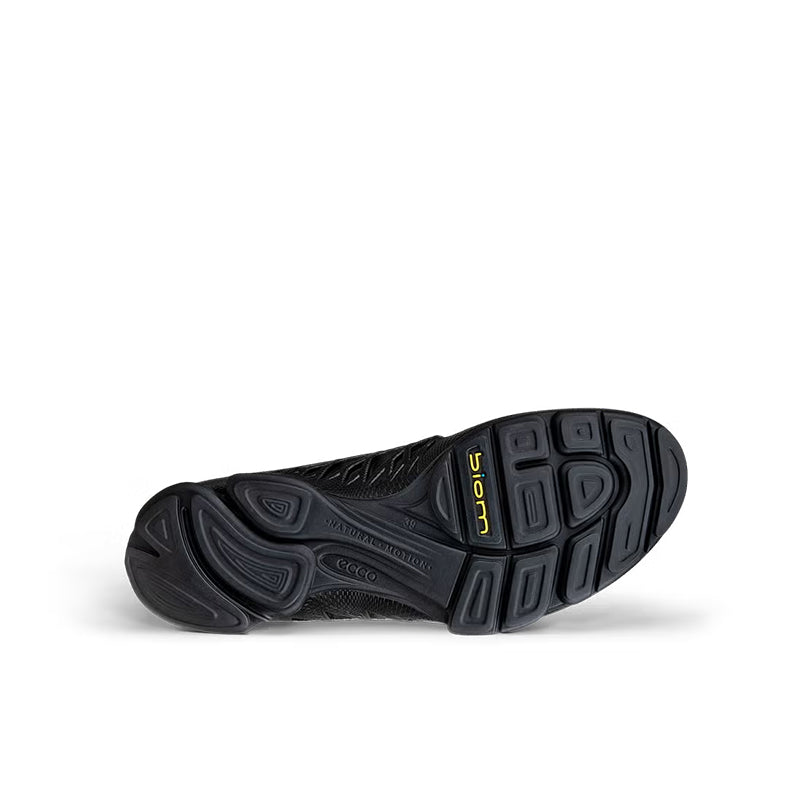 Black leather sneaker outsole with tread pattern and side markings, heel view