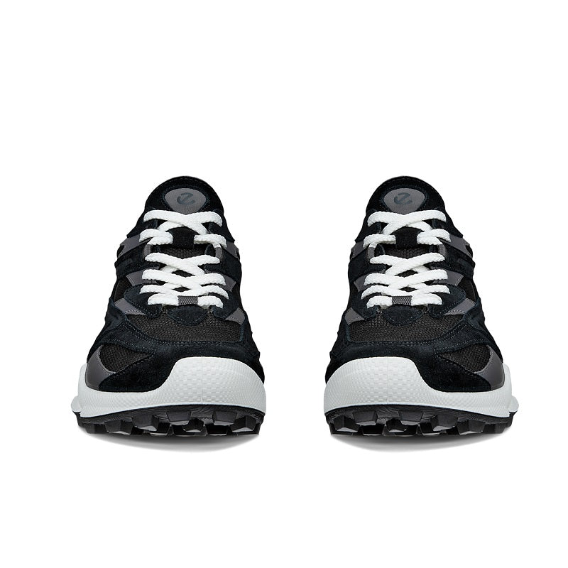 Pair of black women’s trail sneakers with lace-up design and thick treaded outsole