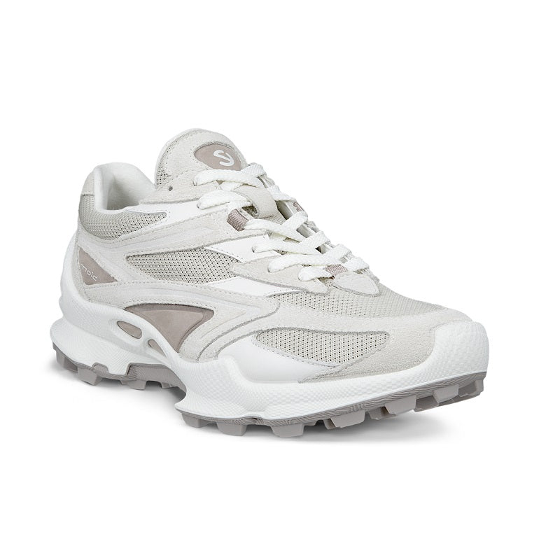 White women’s trail sneakers with lace-up front, mesh panels, and chunky white sole