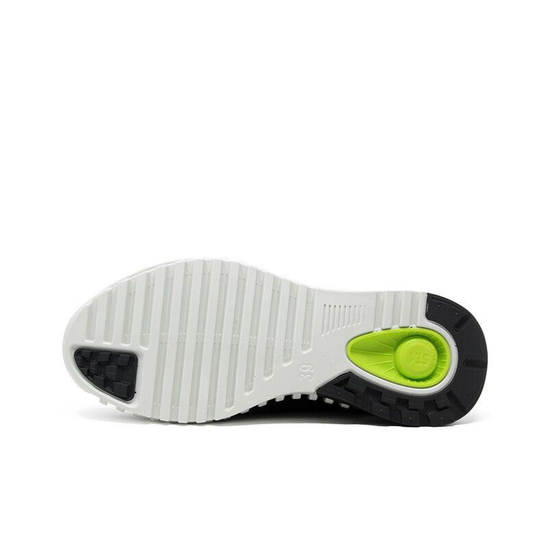 Men's black sneaker outsole with white tread and green traction patch