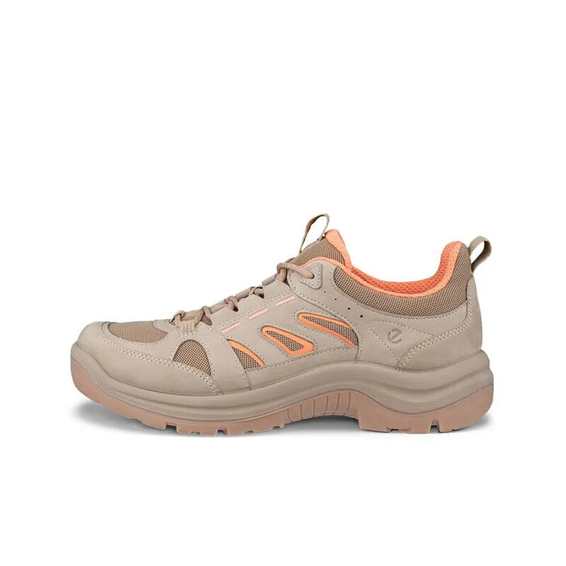 Beige lace-up women's sneaker with orange lining accents and treaded sole