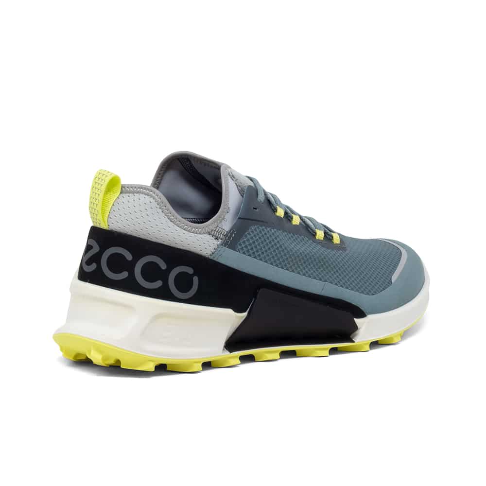 Men's blue-gray slip-on style trail sneakers with neon yellow trim and chunky sole