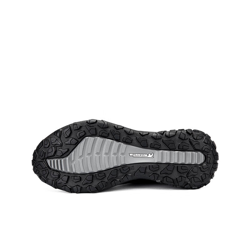 Black sneaker outsole with textured tread and side traction pattern