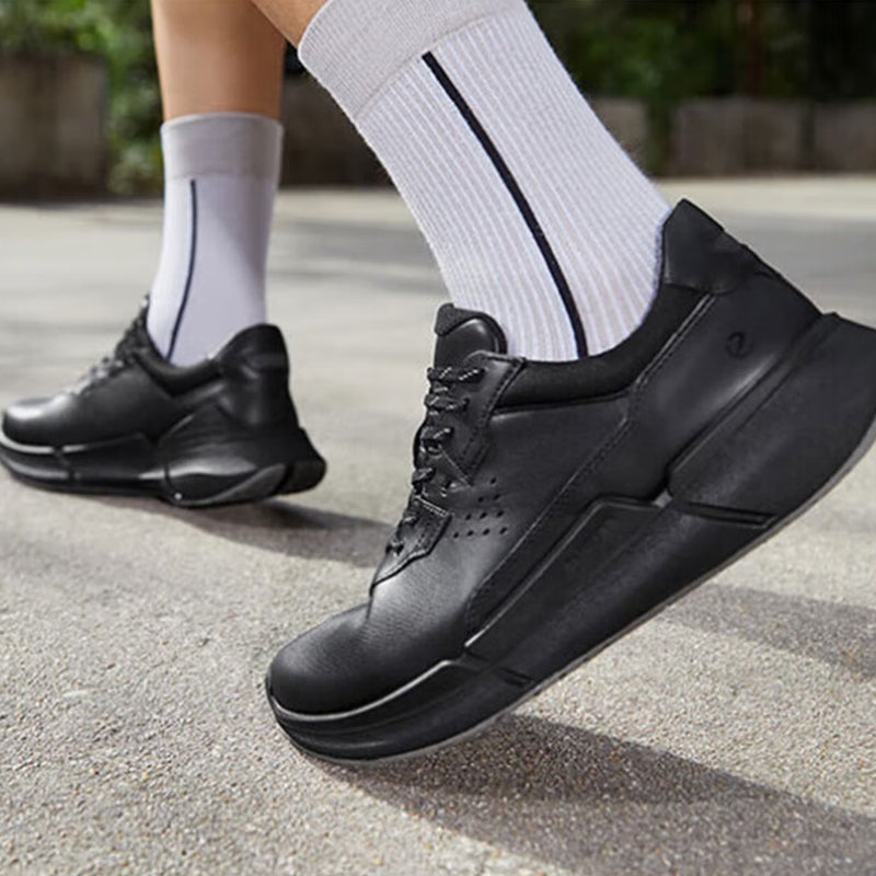 Black men's sneakers with lace-up front and side panel details