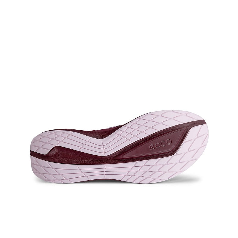 Sneaker outsole view with dark burgundy heel and white rubber tread pattern