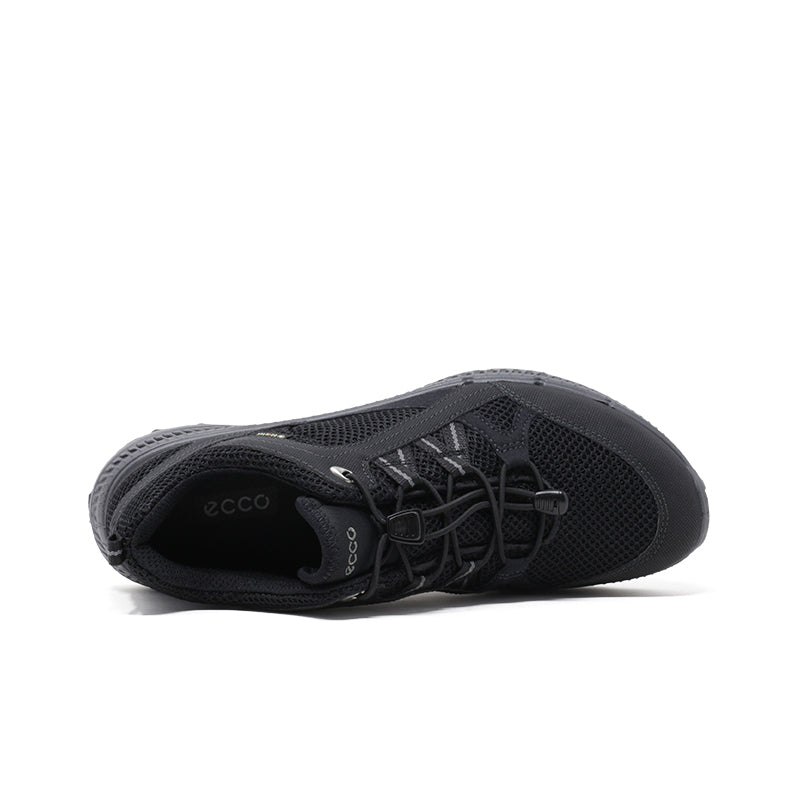 Black women’s sneaker showing tongue, laces, mesh lining, and side panel