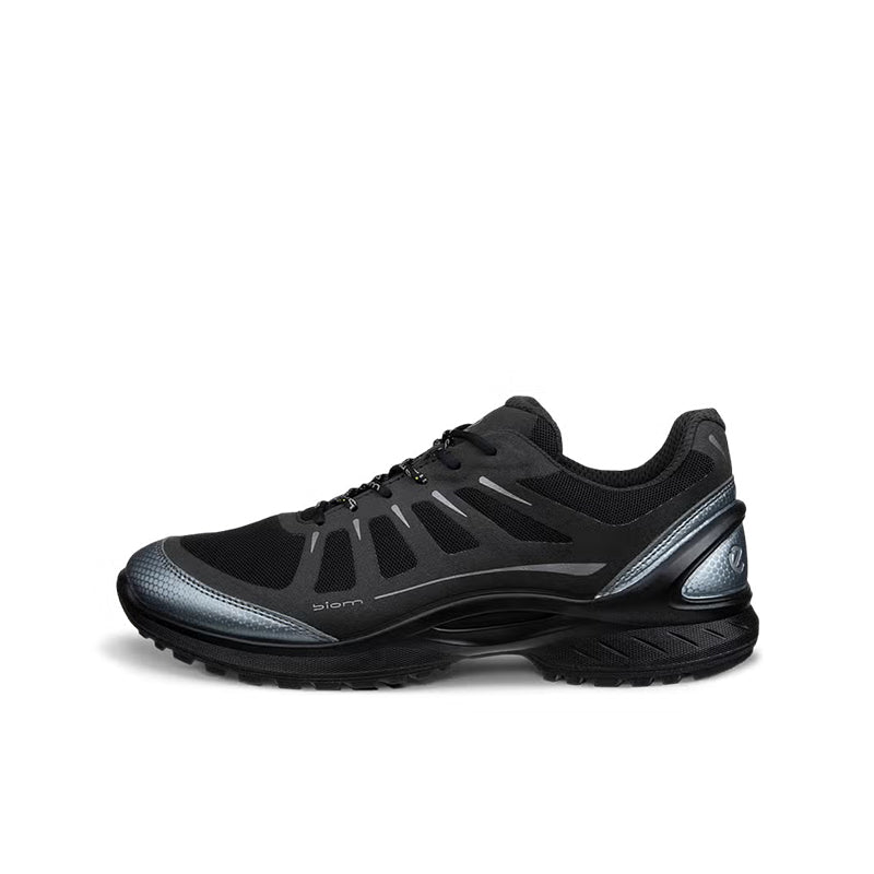 Black lace-up sneakers with textured side panels and chunky tread sole