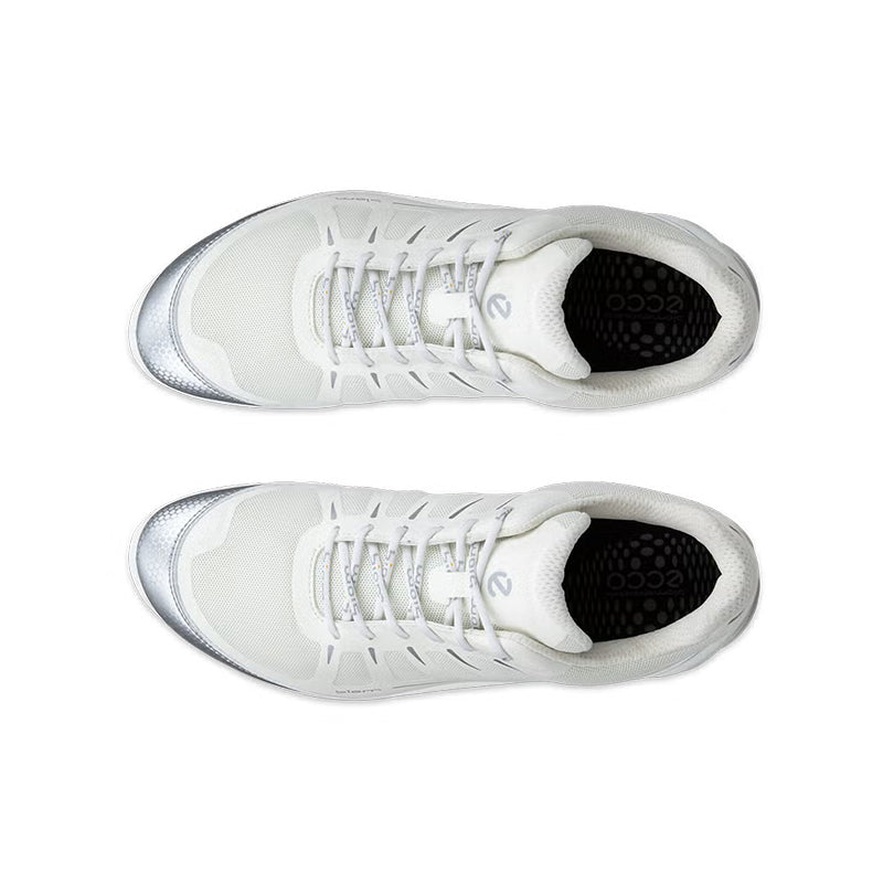 Pair of white lace-up sneakers with black interior lining and cushioned collar