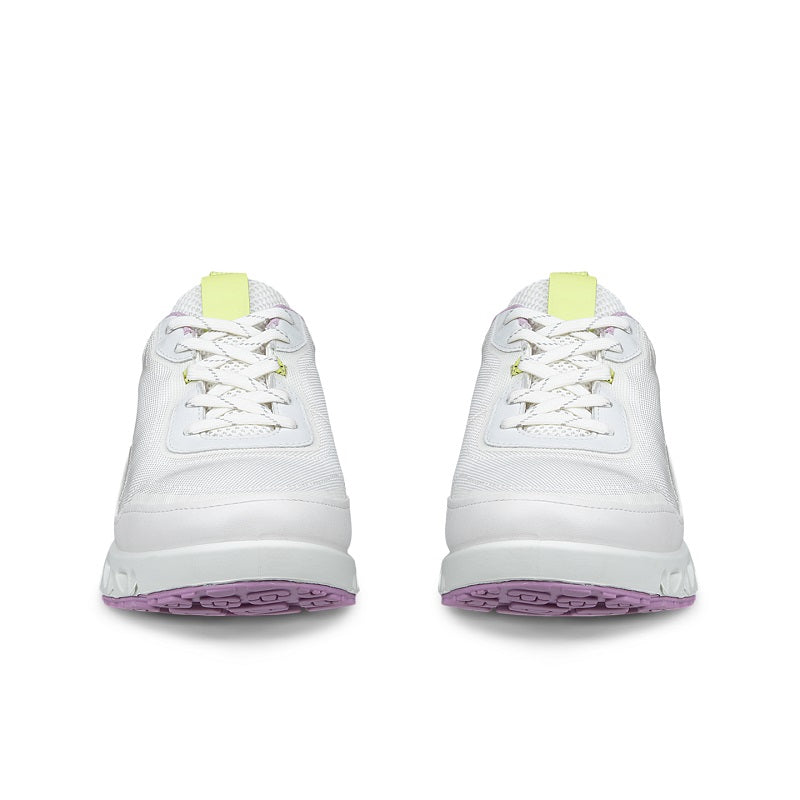 White women's sneakers with neon green heel tab and lavender outsole trim, lace-up front