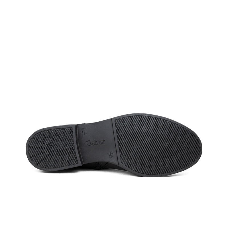 Black boot outsole with textured tread and brand logo patch