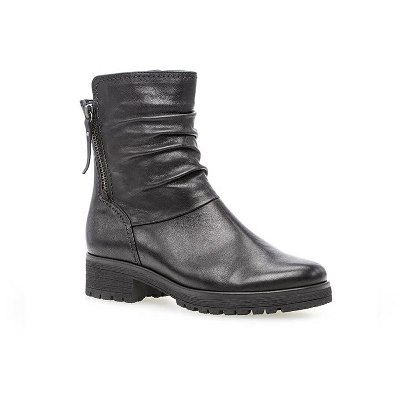 Black leather ankle boots with side zip, lace pull, and chunky tread sole
