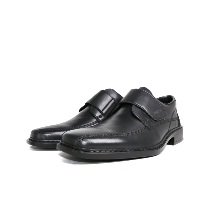 Men’s black leather slip-on dress shoe with front strap detail and flat sole