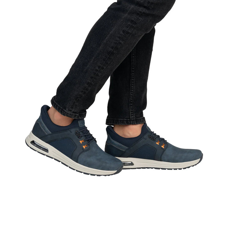 Men's blue sneakers on model with dark jeans, lace-up closure and air-cushion sole
