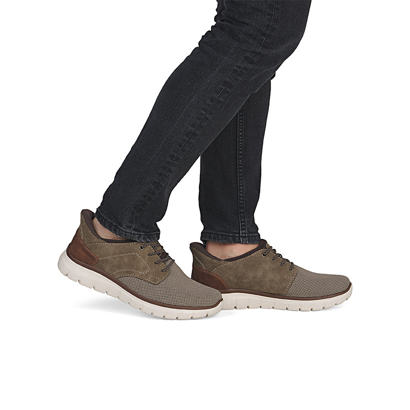 Men’s lace-up casual shoes on feet, taupe suede and knit uppers with white sole