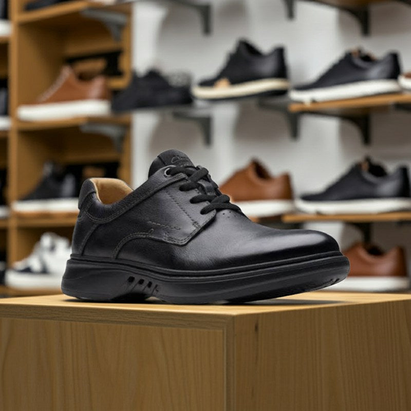 Men's black leather lace-up business shoe with padded collar and textured outsole