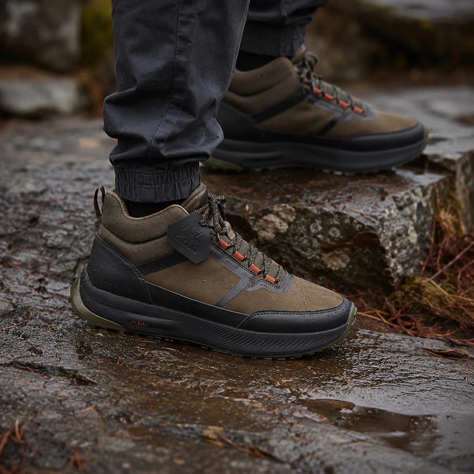 Brown TrailUp WP sneaker close-up on rocky surface with rugged tread sole