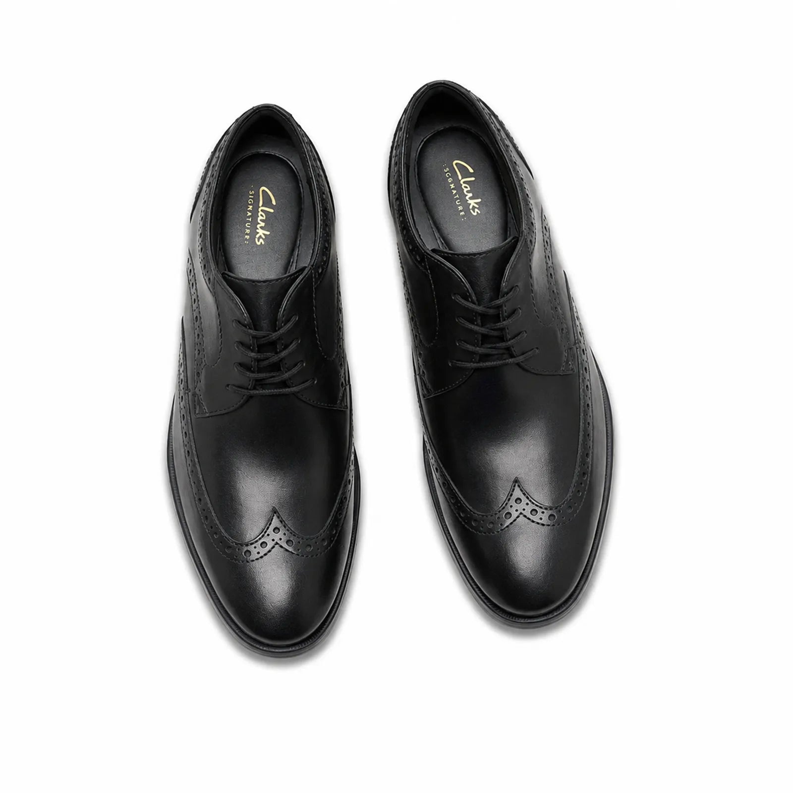 Pair of men's black leather lace-up brogue dress shoes, top view