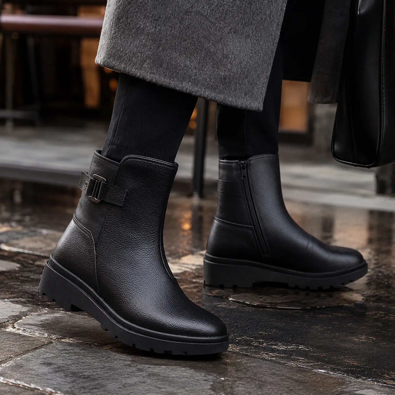 Women’s black leather mid-ankle boots with buckle strap and thick tread sole