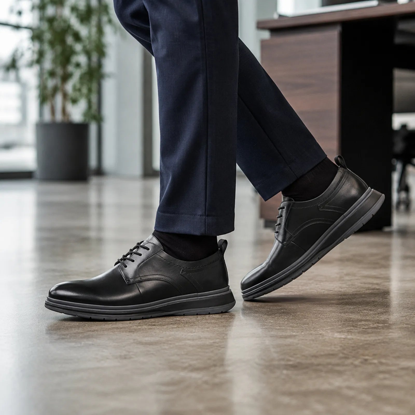 Men's black leather lace-up business shoes with side profile and tread sole