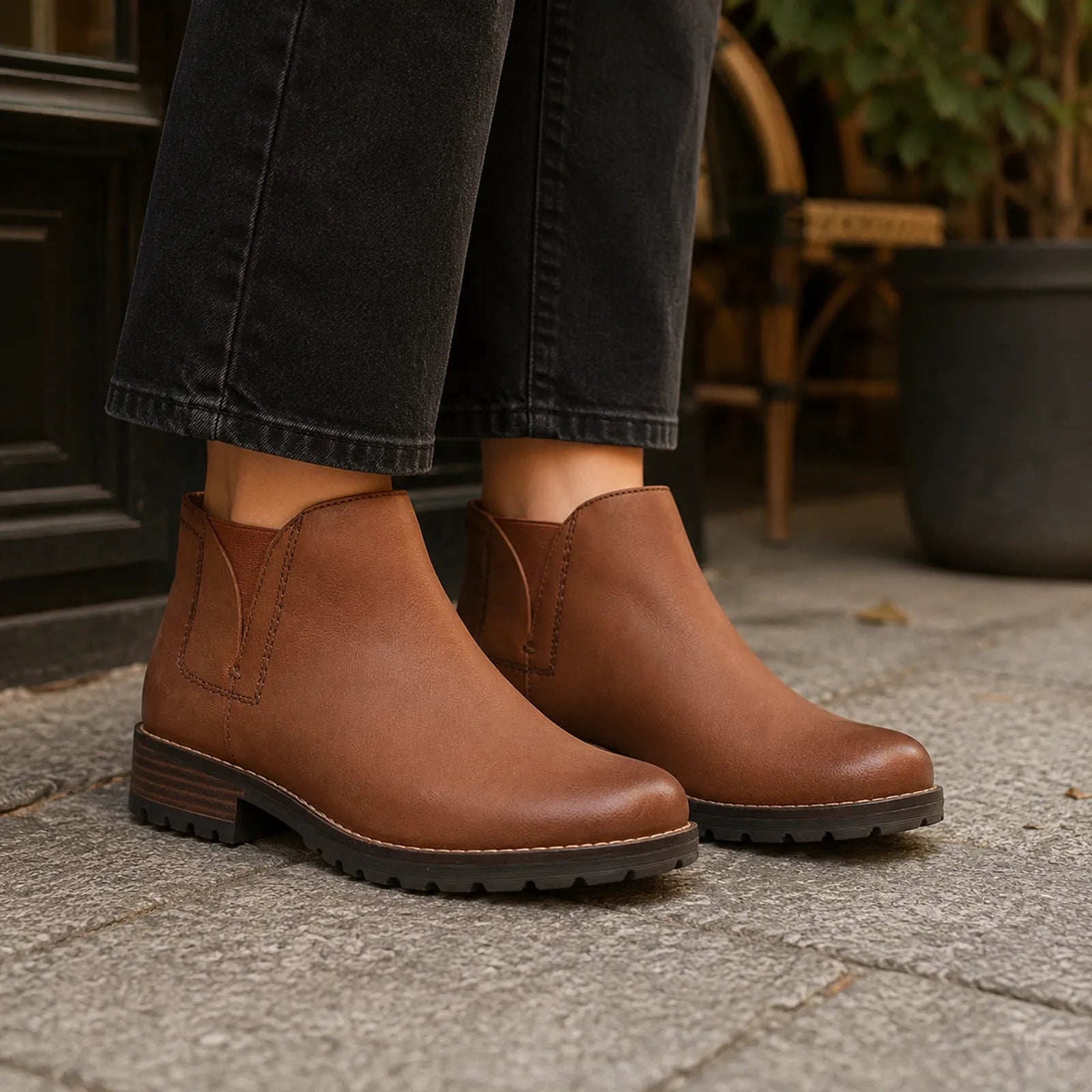 Brown leather ankle boots with elastic sides and textured rubber outsole