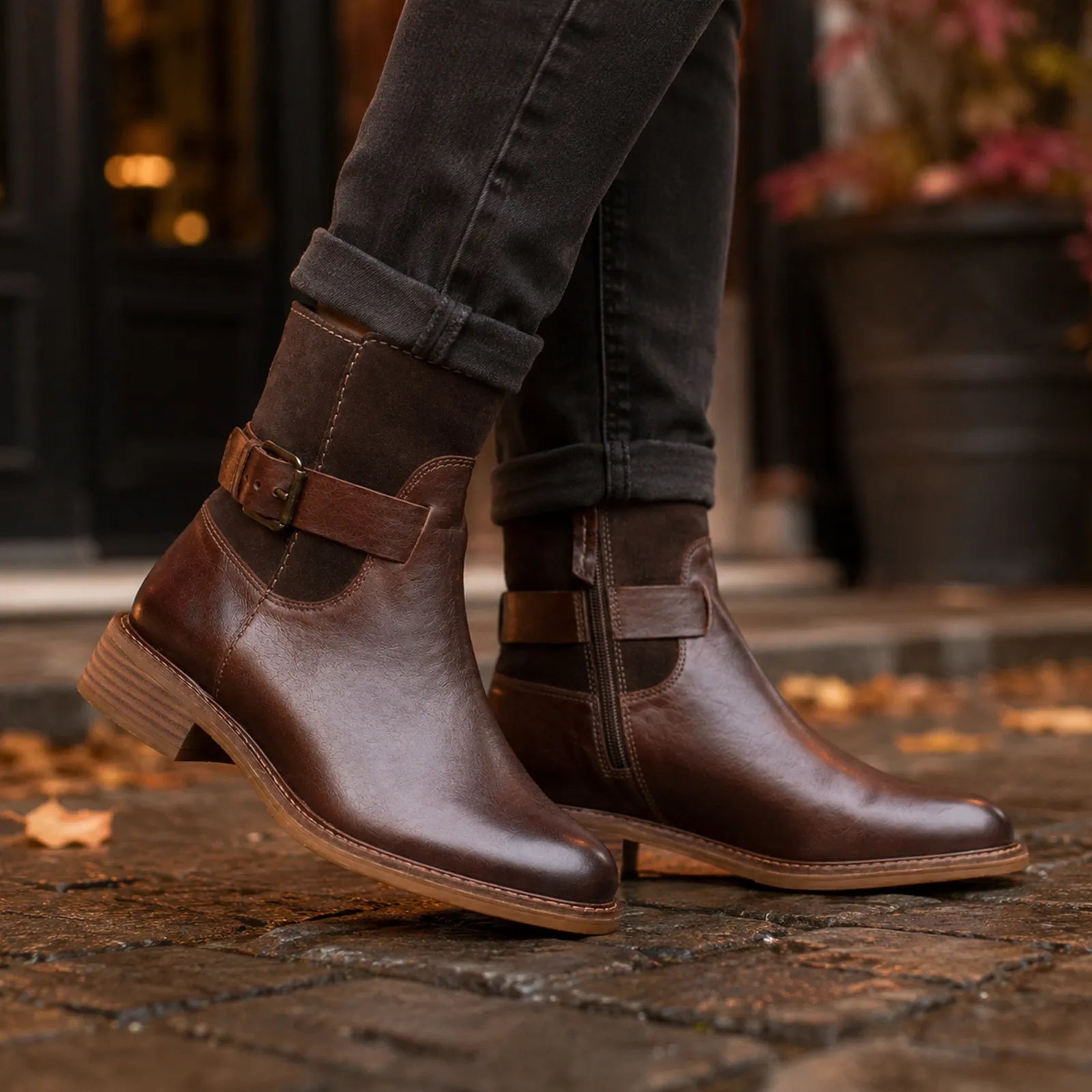 Women’s brown leather ankle boots with buckle strap and low wooden heel, side view