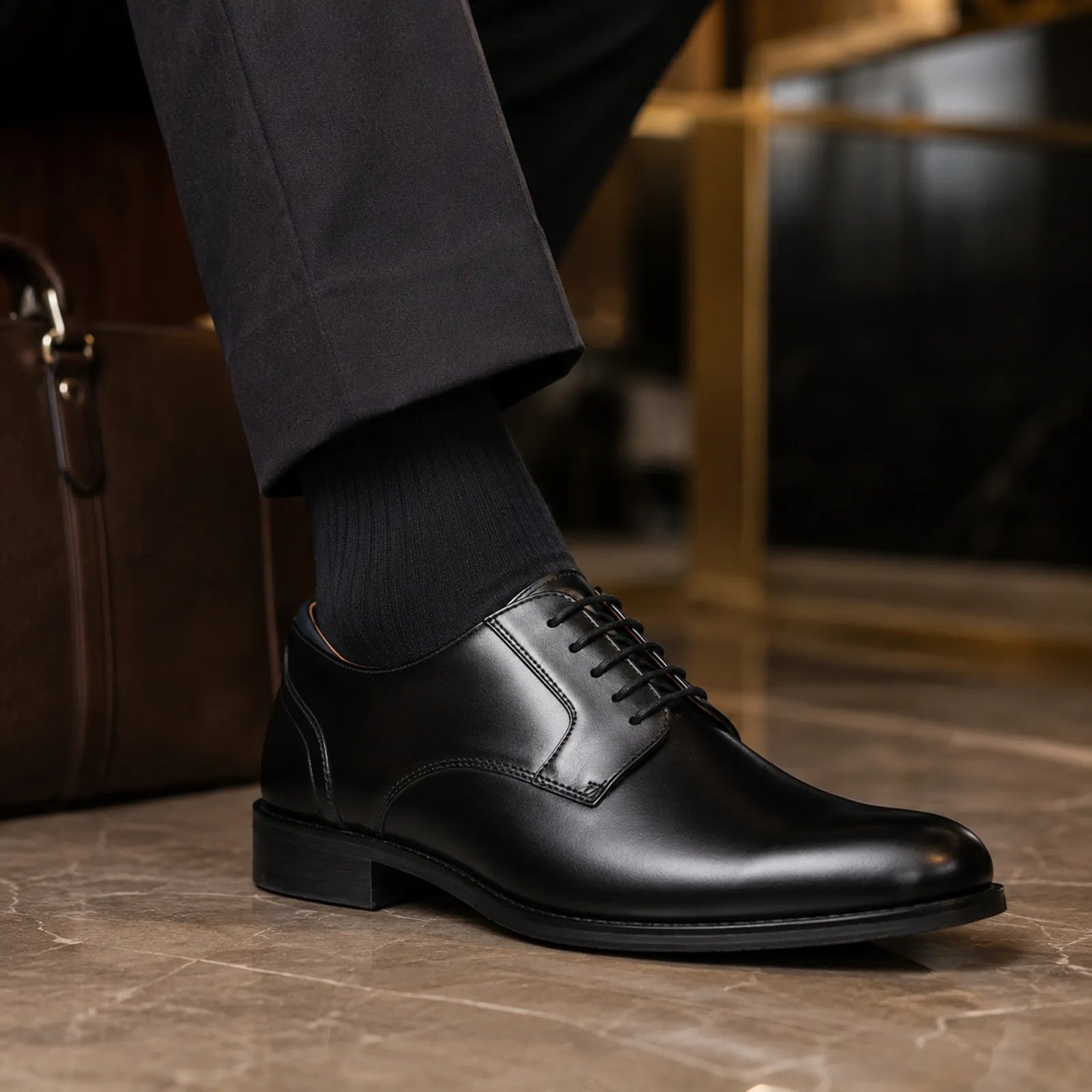 Men's black leather lace-up dress shoe with stitched panel detail and dark laces