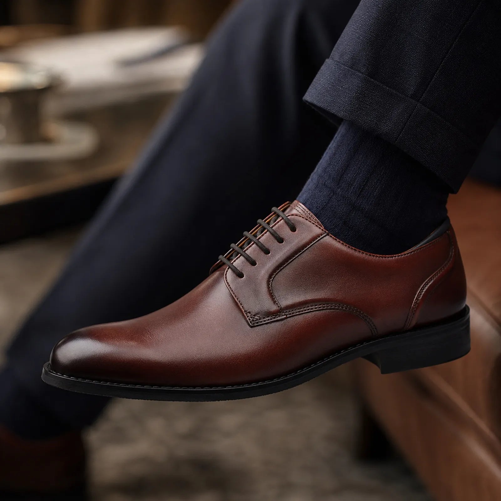 Men's oxblood leather lace-up dress shoes with contrast stitching and dark outsole