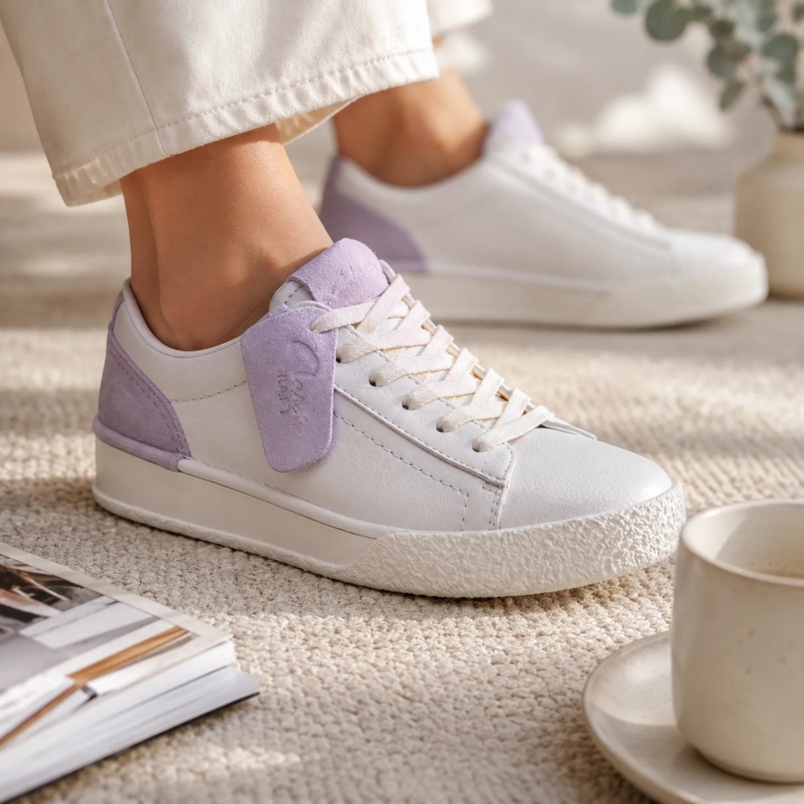 White and lilac leather lace-up sneaker close-up with textured rubber sole