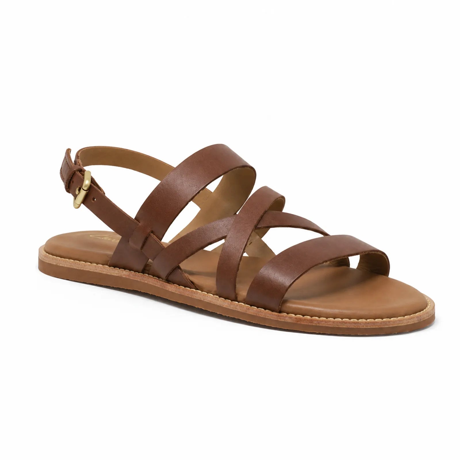 Women's tan leather flat sandal with crisscross straps and gold buckle ankle strap