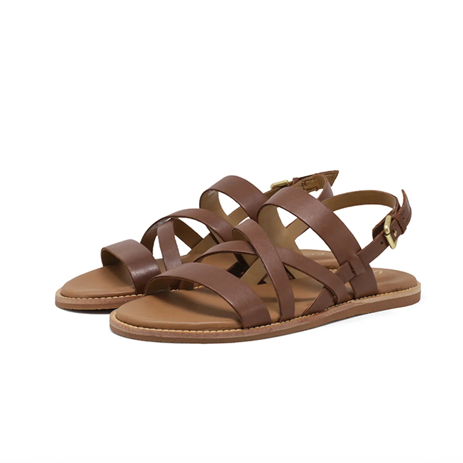 Women's tan leather flat sandal pair with crisscross straps and adjustable buckle