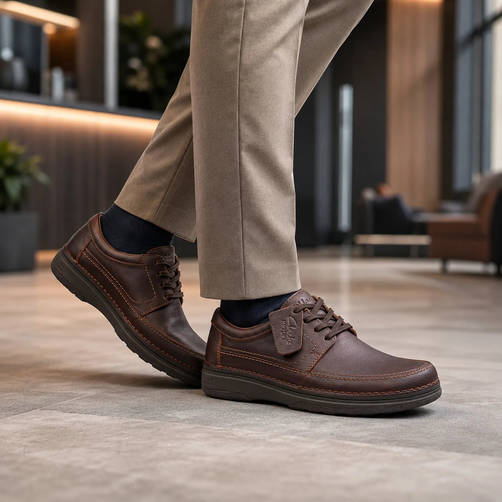 Brown leather lace-up business shoe with side stitching and rubber outsole
