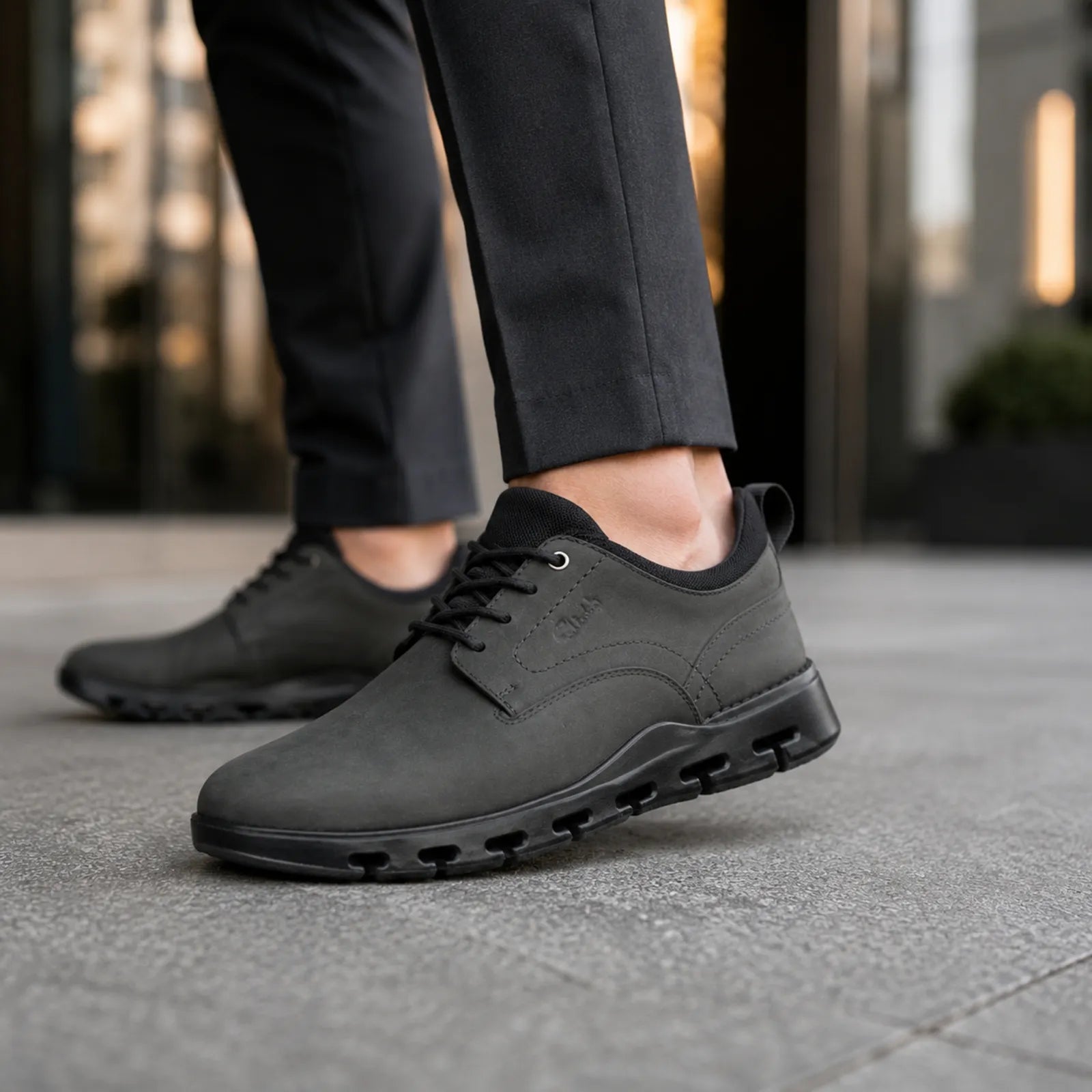 Close-up of men's black lace-up business shoe with textured outsole